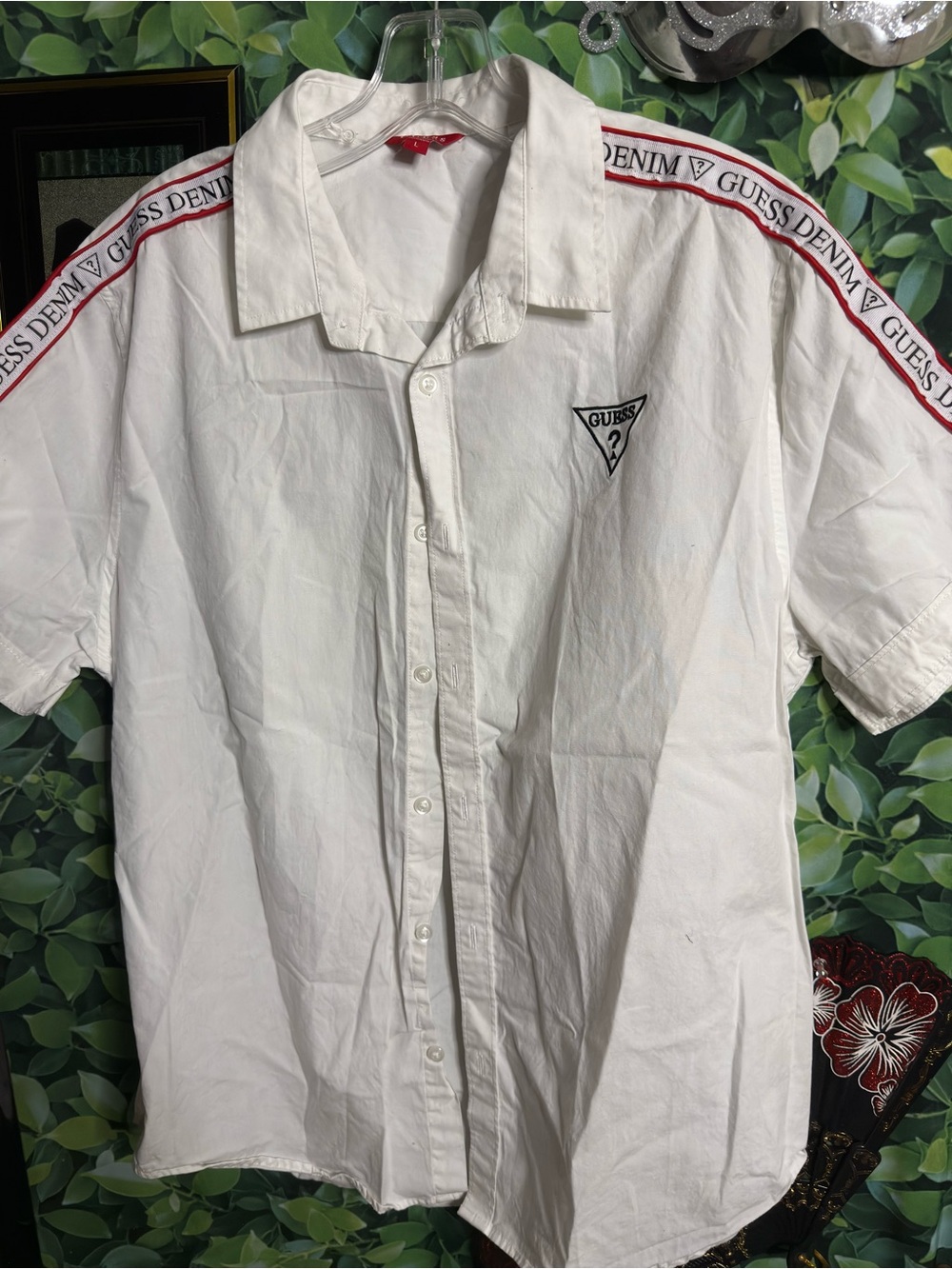 Guess logo button up top